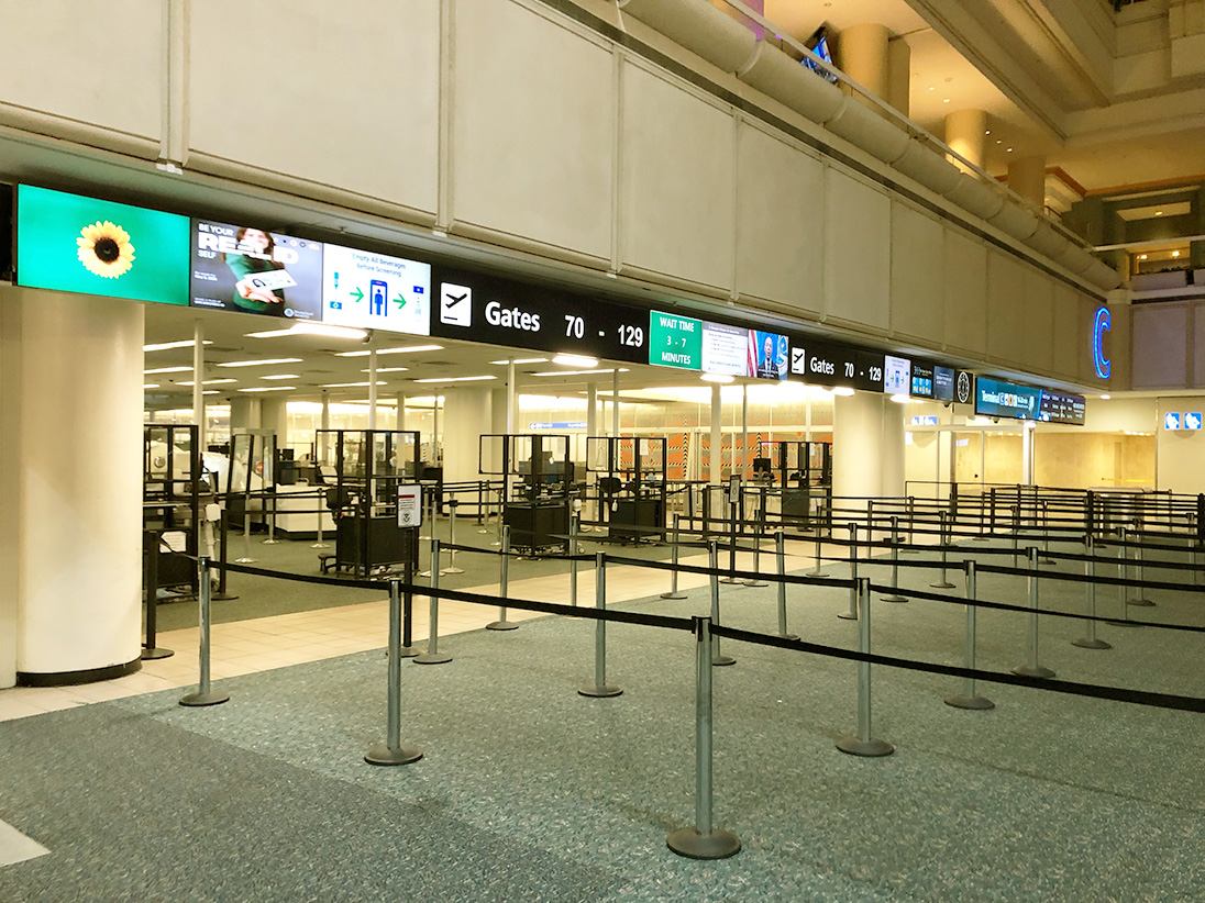 Rare sights to see at Orlando International Airport; empty TSA checkpoint and flight display board with all cancellations